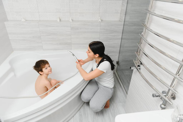 Mother And Son Having Fun At Bath Time Together - Фото, изображение