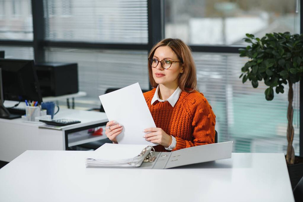 Confident business woman stands in the office - Photo, Image