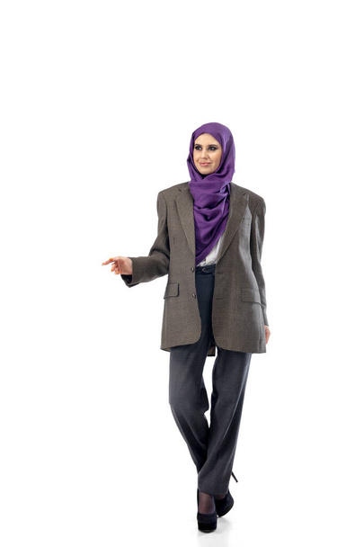 Beautiful arab woman posing in stylish office attire isolated on studio background. Fashion concept - Foto, afbeelding