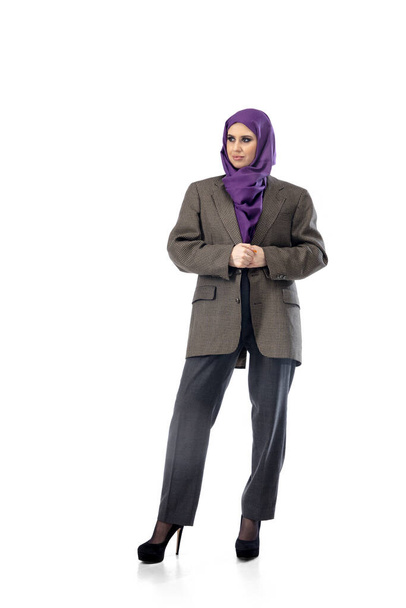 Beautiful arab woman posing in stylish office attire isolated on studio background. Fashion concept - Фото, зображення