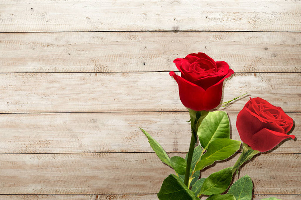Red roses on wooden table background. Valentines day - Fotografie, Obrázek
