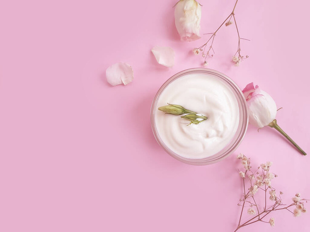 crème cosmétique, rose fleur sur un fond coloré - Photo, image