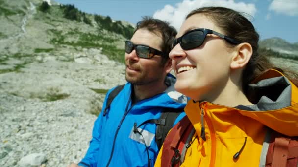 Outdoor active Caucasian adventures male and female hikers viewing the mountain scenery around them British Columbia   - Footage, Video
