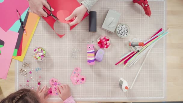 Flat lay. Kids papercraft. Making paper bugs out of the empty toilet paper rolls and construction paper. - Footage, Video