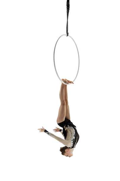 Young female acrobat, circus athlete isolated on white studio background. Training perfect balanced in flight - Fotografie, Obrázek