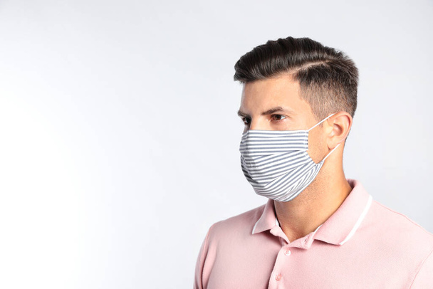 Man in protective face mask on white background - Fotografie, Obrázek