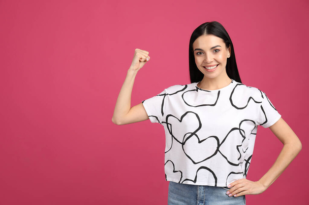 Strong woman as symbol of girl power on pink background, space for text. 8 March concept - Foto, imagen