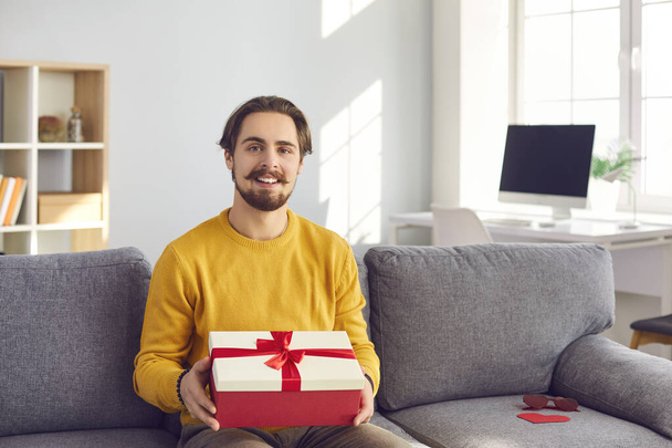 Man on webcam shows his girlfriend a gift he prepared for her in honor of her holiday. - Photo, Image