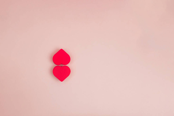 two red hearts on a pink background. High quality photo - Foto, Imagem