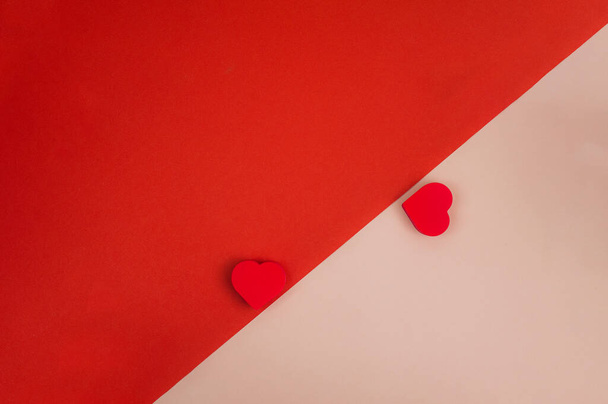 two red hearts on a red-pink background. High quality photo - Fotografie, Obrázek