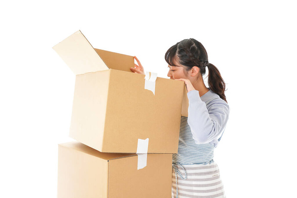 young woman with a stack of cardboard boxes isolated on white background - Photo, Image