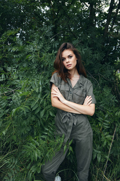 Woman in forest crossed her arms and jumpsuit nature travel  - Foto, Imagen