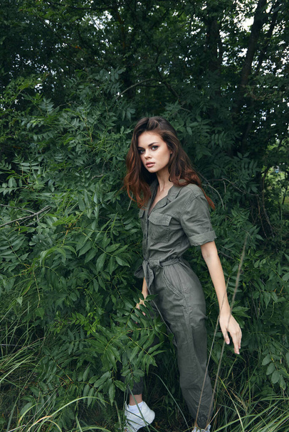 Portrait of a woman In Green Overalls near the Bushes nature travel cropped view - Фото, зображення
