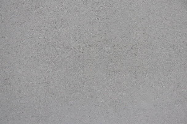 Grijze pleister op de muur van het gebouw. - Foto, afbeelding