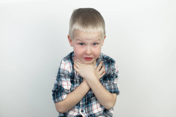 A pediatrician examines a boy who complains of a sore throat. Diagnosis of tracheal diseases. Angina, tonsillitis, pharyngitis, pain in the nasopharynx. Children medical care concept - Photo, Image