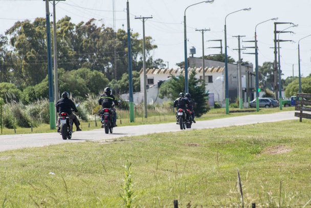 Mottards riding their bikes ona narrow road                        - Photo, Image