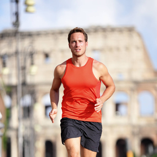 Runner man running at Rome marathon near Colosseum - Foto, imagen