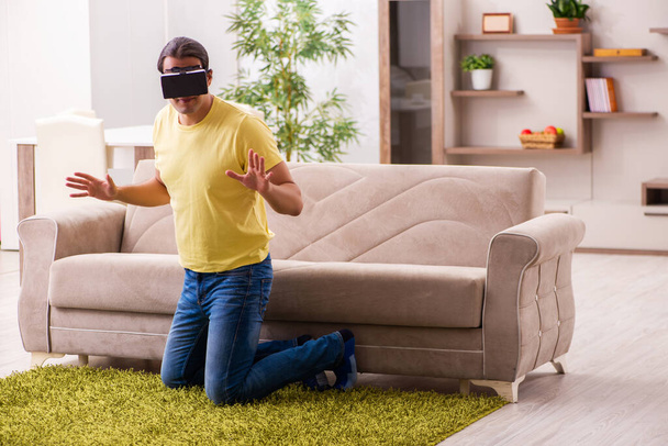Young man student with virtual glasses at home - Photo, image