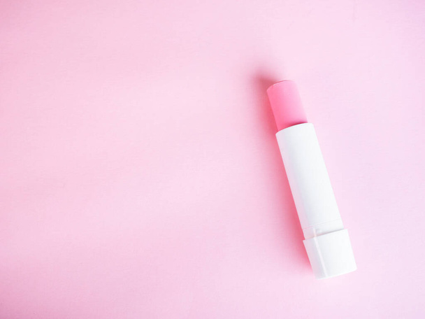 Simple pink lip balm on pink background - 写真・画像