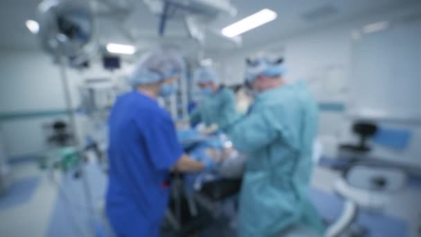 Blurred bokeh background of surgery in operating room of medical hospital clinic. - Footage, Video