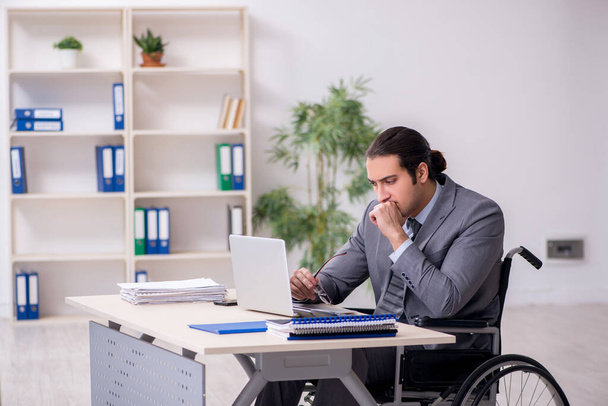 Young male employee in wheel-chair - Photo, image
