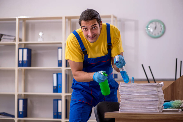 Young male contractor cleaning the office - Fotografie, Obrázek