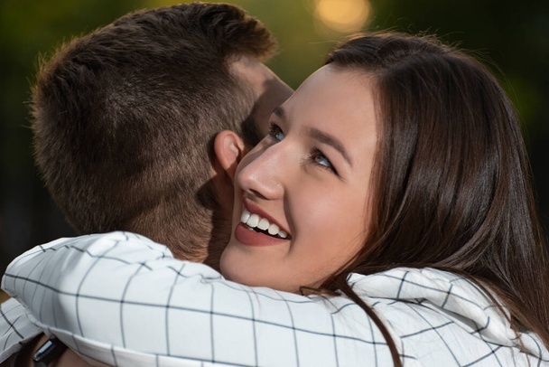 Close up portrait of couple in love while hugging. Happy young people. - Foto, Bild