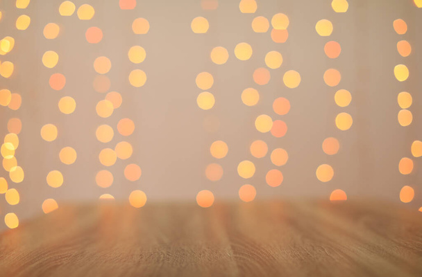 Empty wooden surface and blurred lights on background. Bokeh effect - Photo, Image