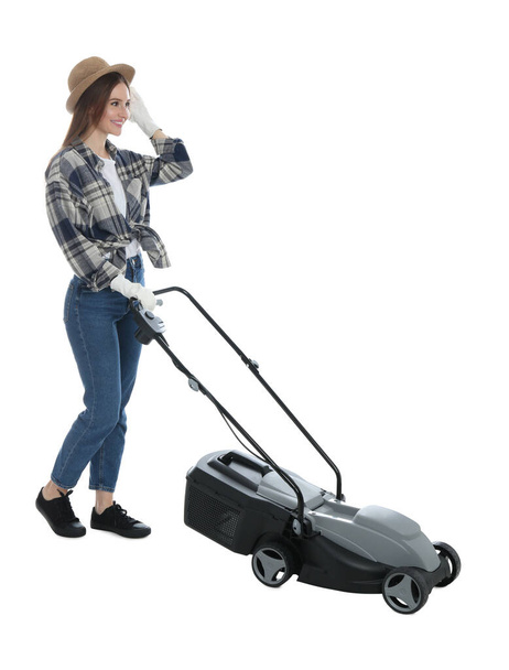 Young woman with modern lawn mower on white background - Foto, Imagen
