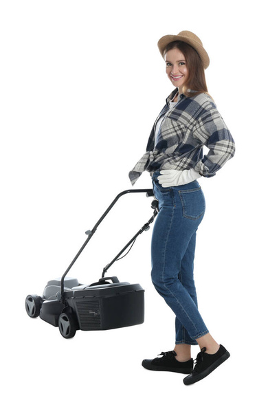 Young woman with modern lawn mower on white background - Valokuva, kuva