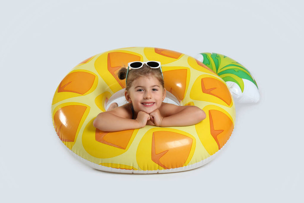 Cute little child in beachwear with bright inflatable ring on white background - Φωτογραφία, εικόνα