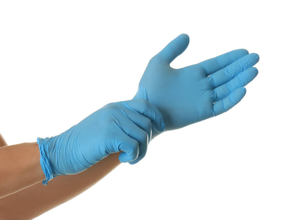 Person putting on blue latex gloves against white background, closeup - Φωτογραφία, εικόνα