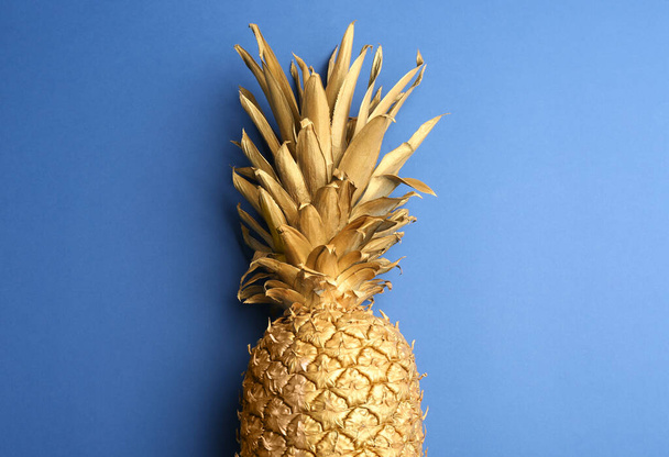 Golden pineapple on blue background, top view. Creative concept - Fotoğraf, Görsel