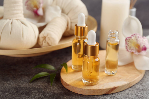 Beautiful spa composition with essential oils on grey table, closeup - Φωτογραφία, εικόνα