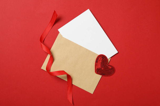 Blank card, decorative heart and ribbon on red background, flat lay with space for text. Valentine's Day celebration - Fotó, kép