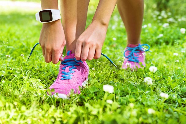 Active lifestyle smartwatch runner tying shoes - Fotografie, Obrázek