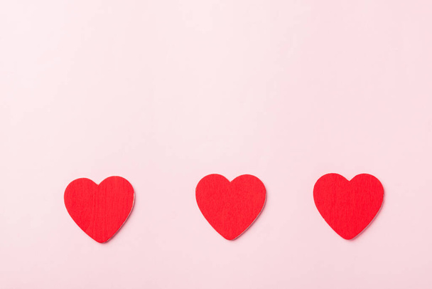 Valentines' day background. red hearts composition greeting card for love Valentines day concept isolated on pink background with copy space. Top View flat lay from above - Photo, image