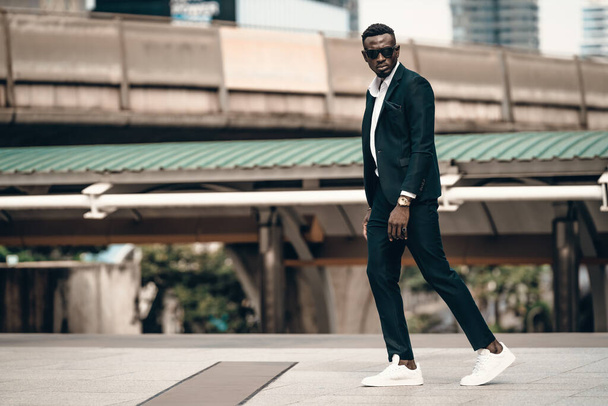 portrait of success and confident african businessman outdoor posing outdoor in modern city. - 写真・画像