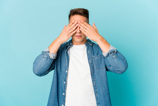 Young caucasian handsome man isolated afraid covering eyes with hands. - Photo, Image