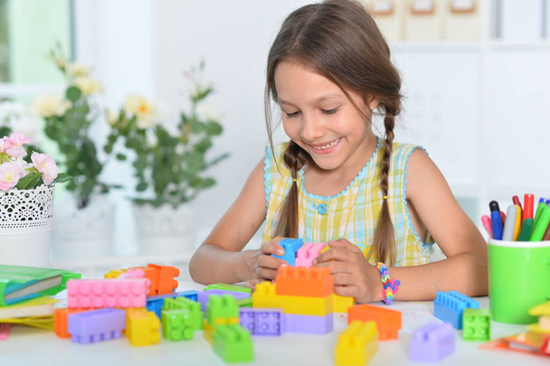 happy cute little girl playing with cubes - Photo, Image