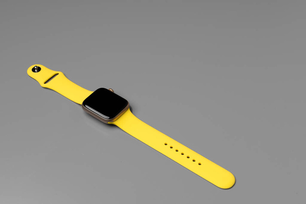 Yellow smartwatch on gray background close up - Photo, Image