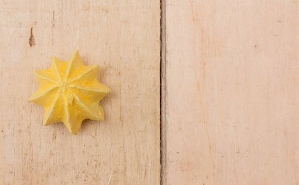 Yellow, sweet, crispy meringue on a wooden background. - Photo, image