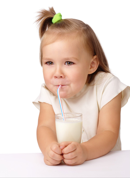 Little girl drinks milk using drinking straw - Zdjęcie, obraz