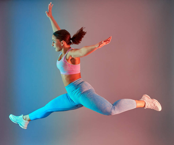 Confident plus size young woman working out fitness exercises, dual tone blue red - Fotó, kép
