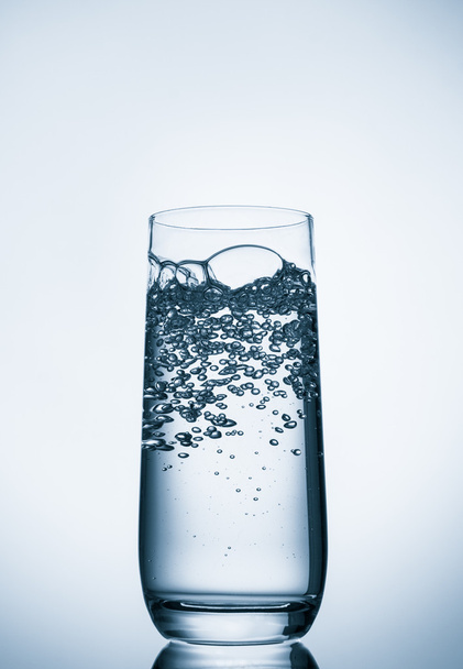 water glass on blue background - Foto, Imagen