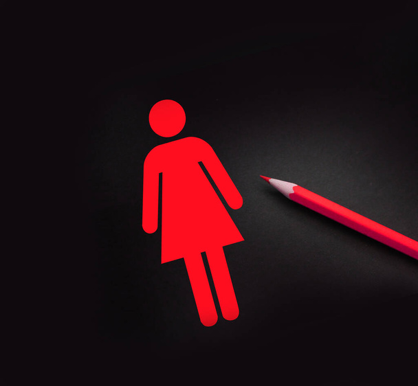 Ícone de mulher e lápis amarelo em preto. Questões de género e conceito dos direitos das mulheres. - Foto, Imagem
