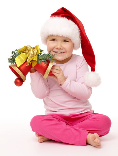 Little girl holds red Christmas bells - Foto, Imagem