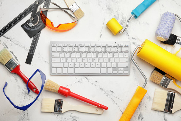 Painting tools and computer keyboard on light background - Photo, Image