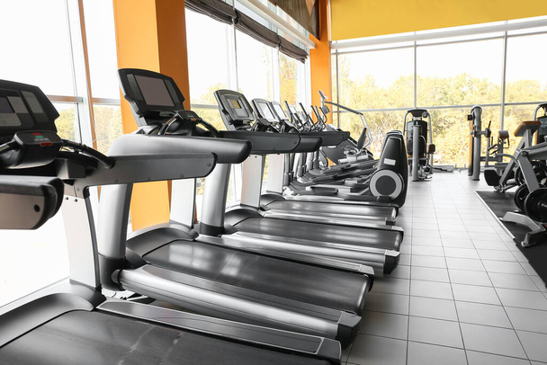 Interior of modern gym with treadmills - 写真・画像