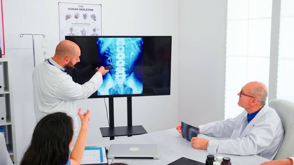 Expert doctor holding medical training pointing on digital x-ray - Photo, Image